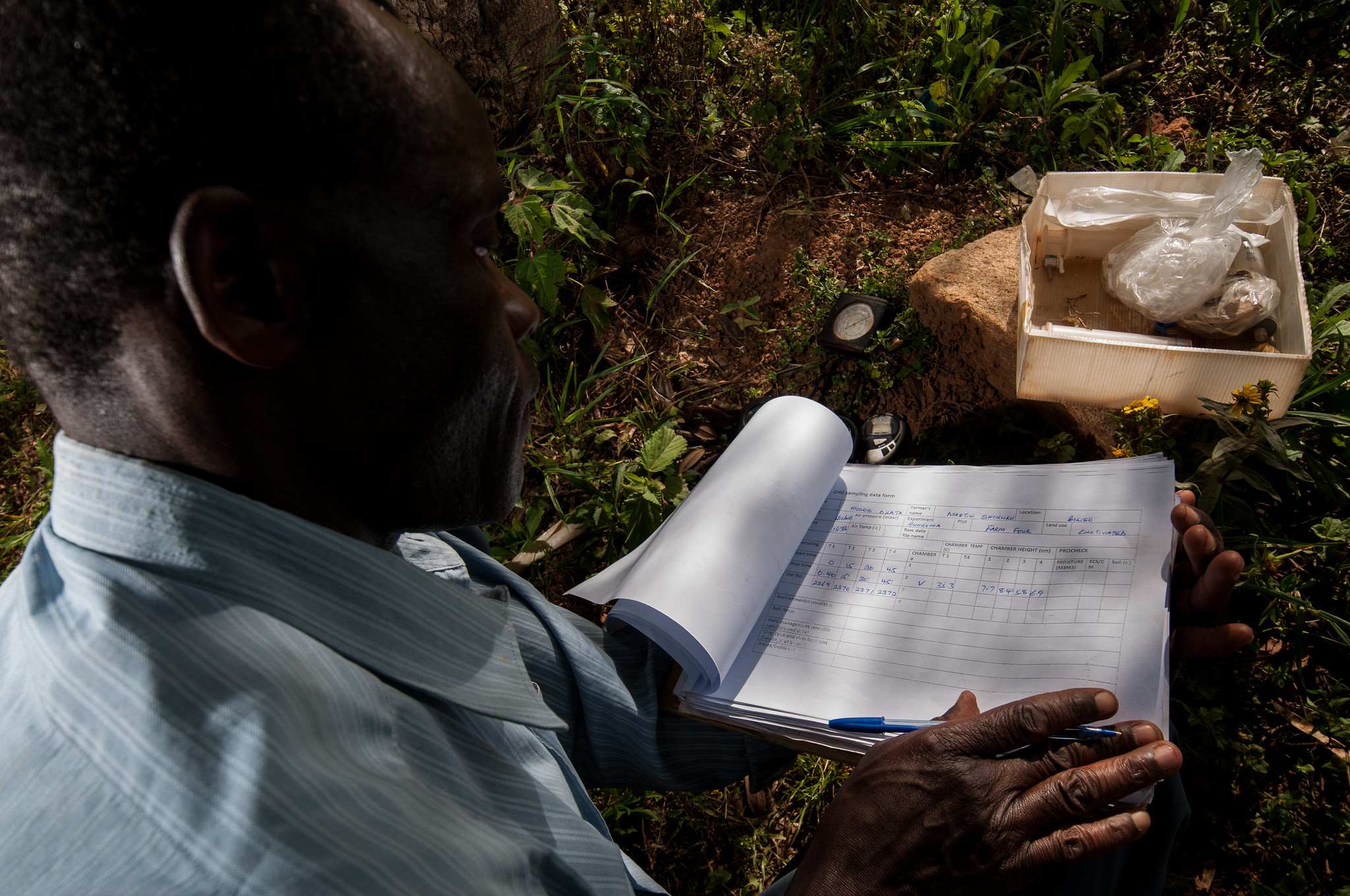 Man writes notes outdoors