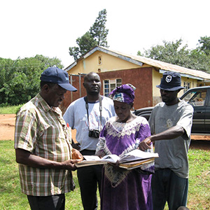 Four people discussing outside a house, photo.