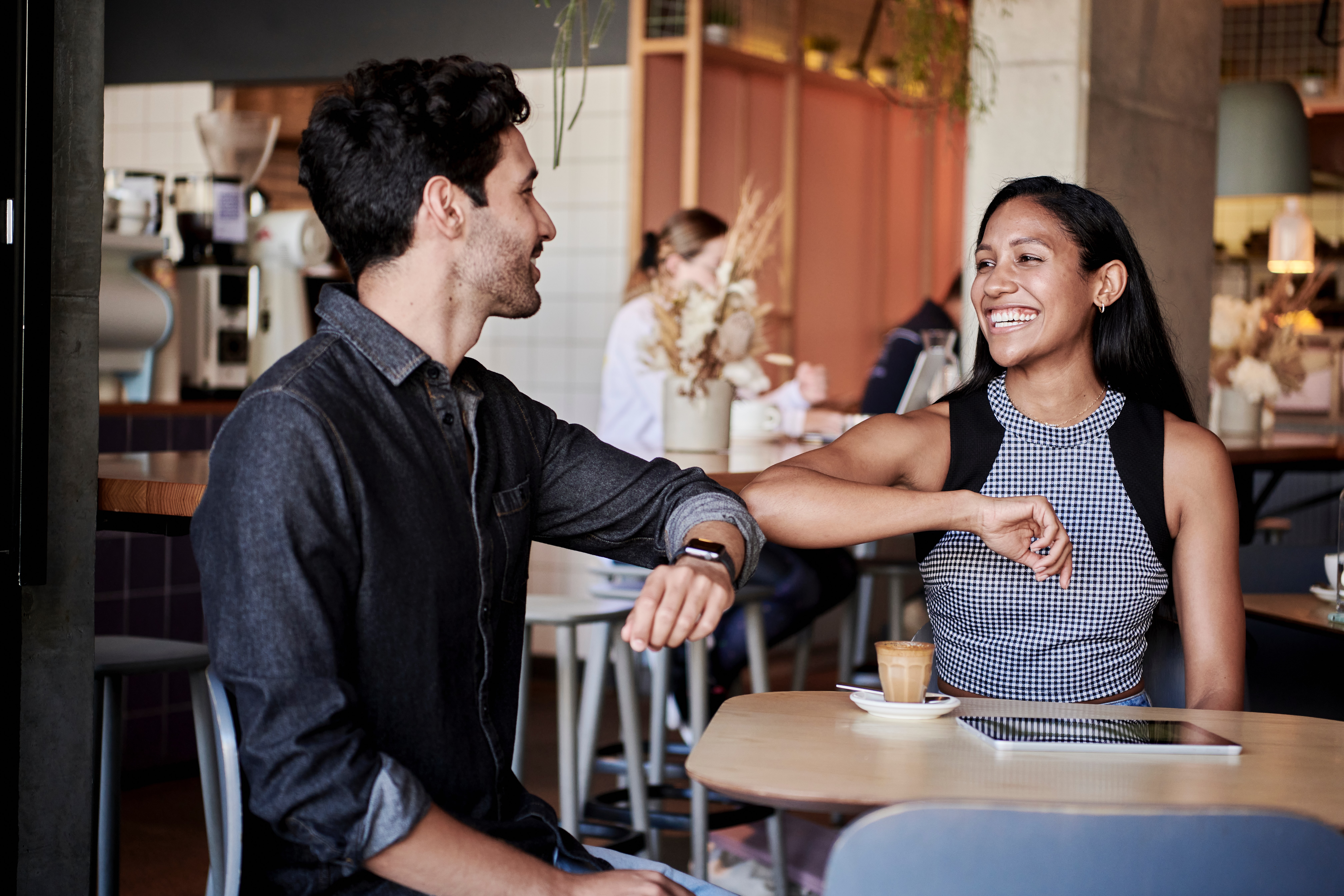 Two people at a table looking at each other
