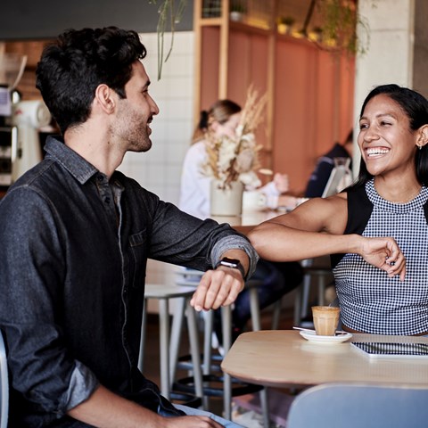 Two people at a table looking at each other