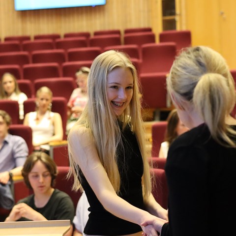 A female high school student receives a diploma