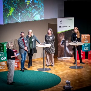 Fem personer på en scen. Foto.