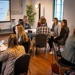 People around a table. Photo.
