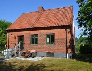 Färgfoto som föreställer Trädgårdsmästarbostaden, ett rött tegelhus, där Pom och Nationella genbanken har sitt kontor. 