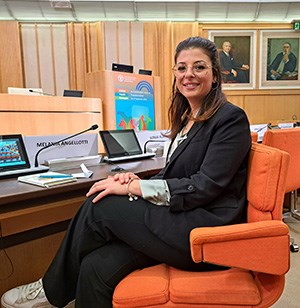 Melania Angelotti sitting at her place at an FAO meeting. Photo. 