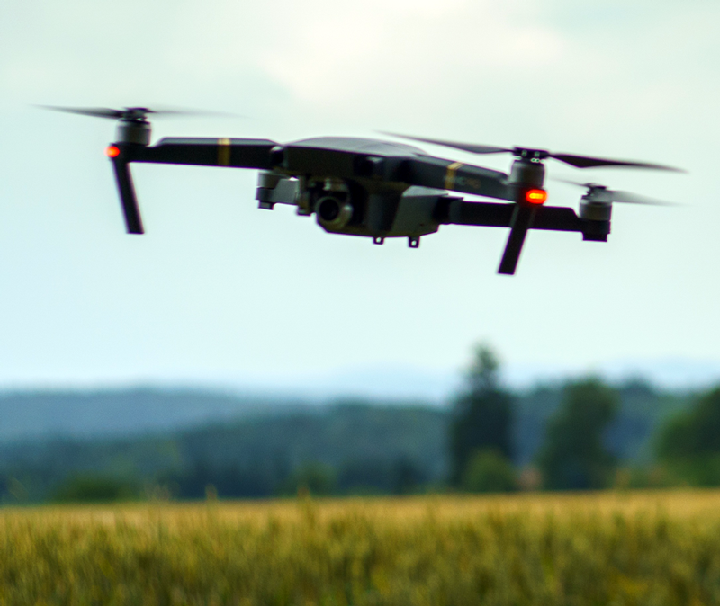 A drone is flying over a field, photo.