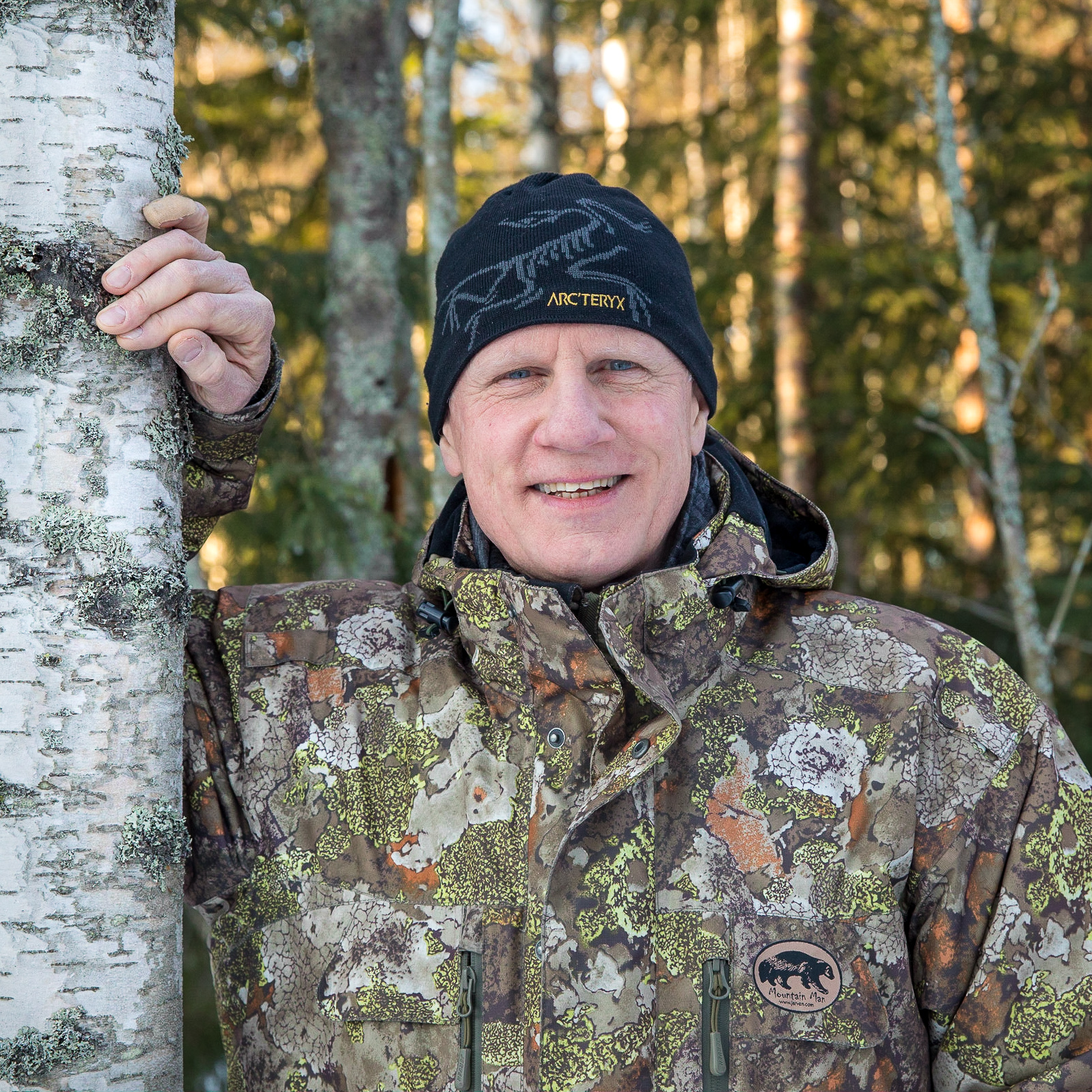 Man next to a birch. Photo.