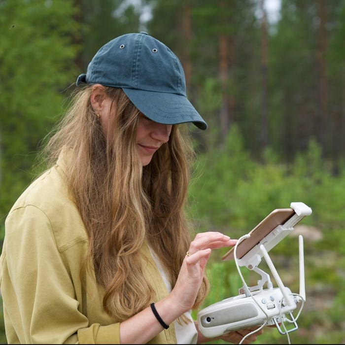 Woman operating a drone.