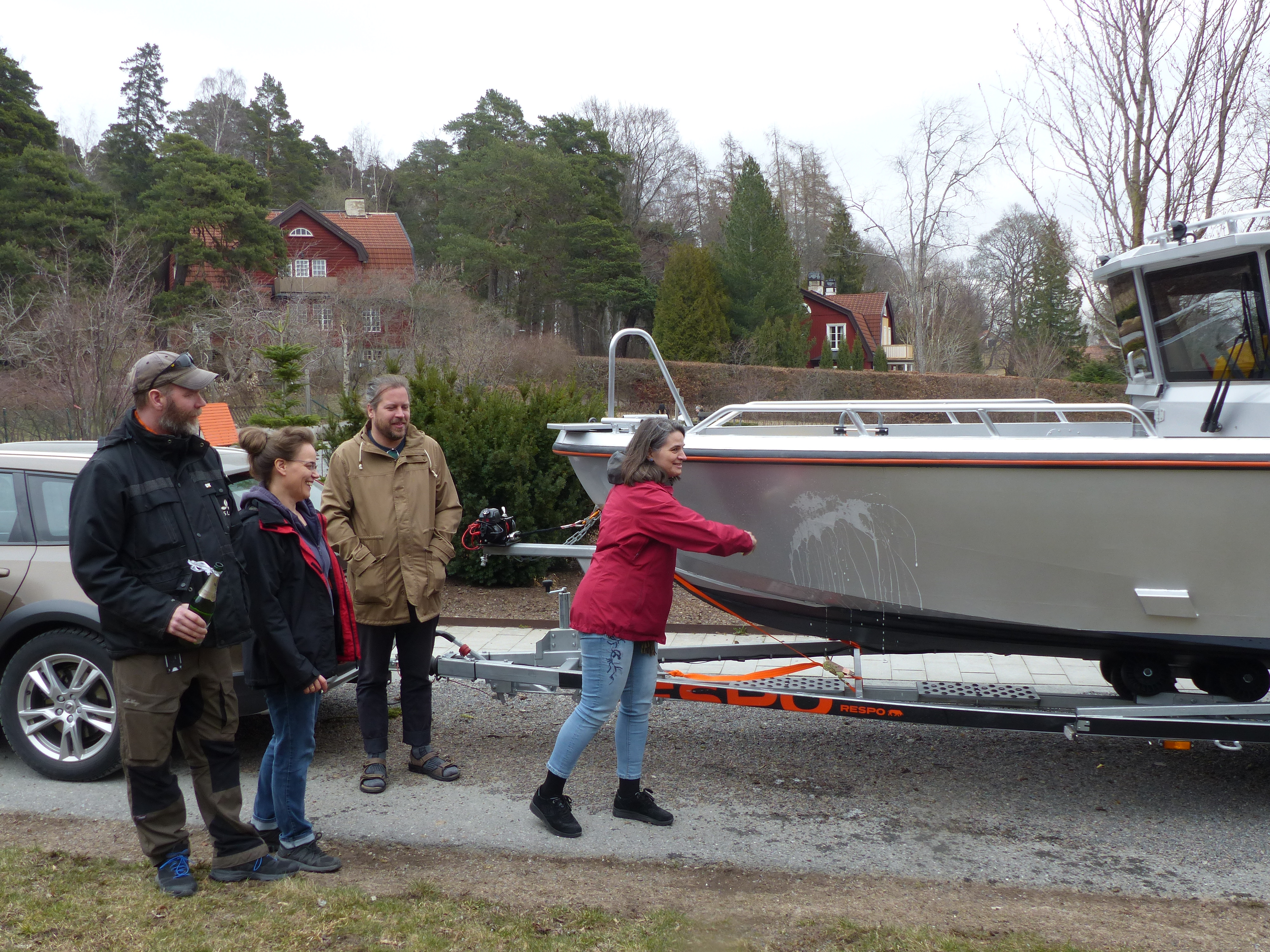 Woman naming a boat. Photo.