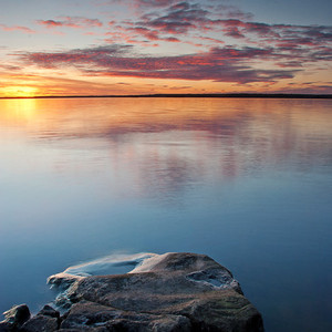 A lake. Rocks in the foreground, photo.
