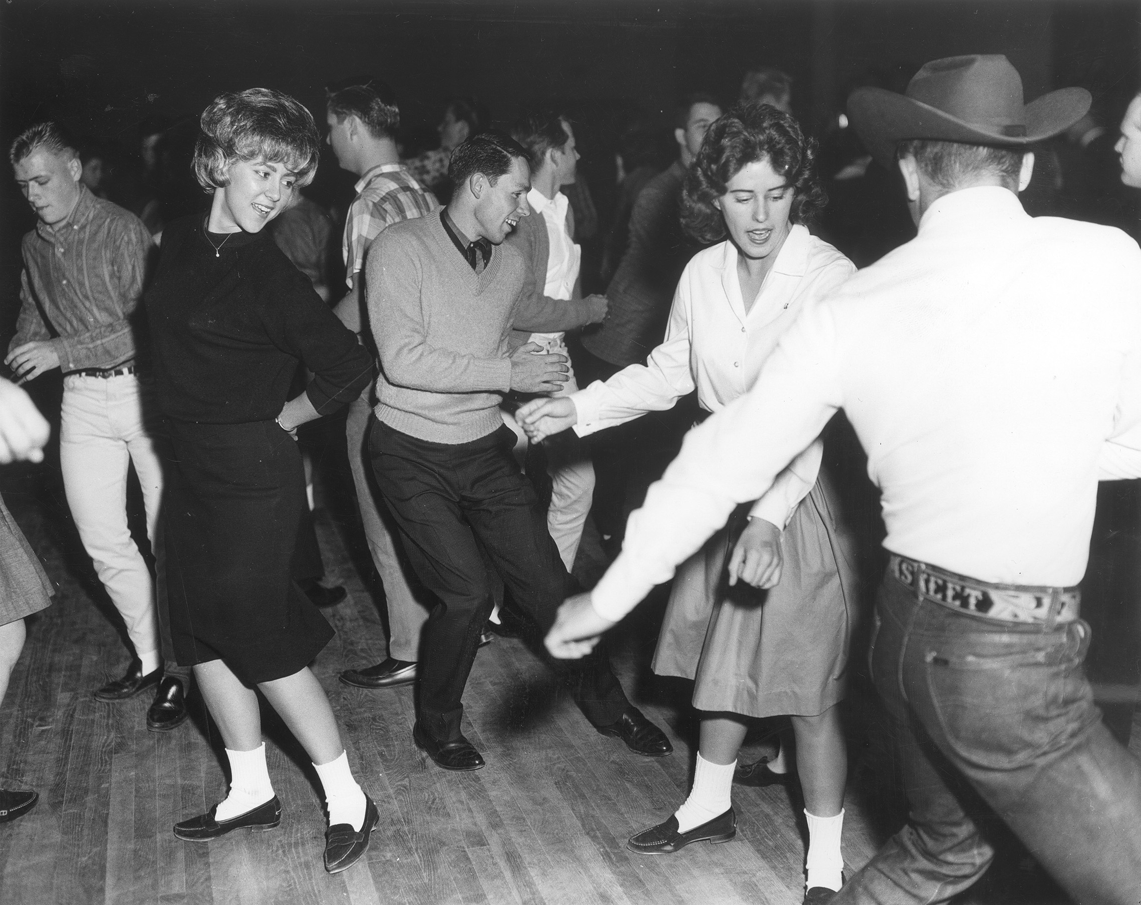 Happy youth dancing, vintage black and white photograph. 