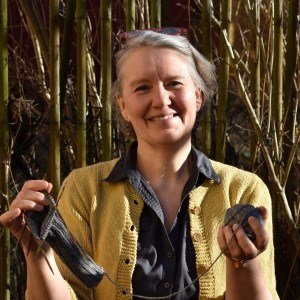 Rebecca Liljefors holding a knitting project, photo.