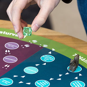 Hand moving game pieces. Photo.