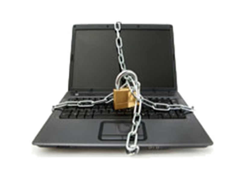 Laptop with chain and padlock. Photo.