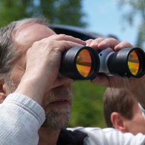 Man with binoculars. Photo.
