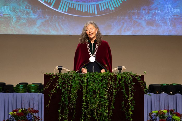 Picture of SLU's Vice-chancellor wearing the red mantel and standing at the parnassus during the doctoral award ceremony.