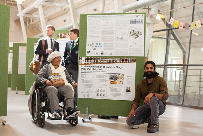 Participant Mujeeb Zia by his poster. Photo: Anton Caringer